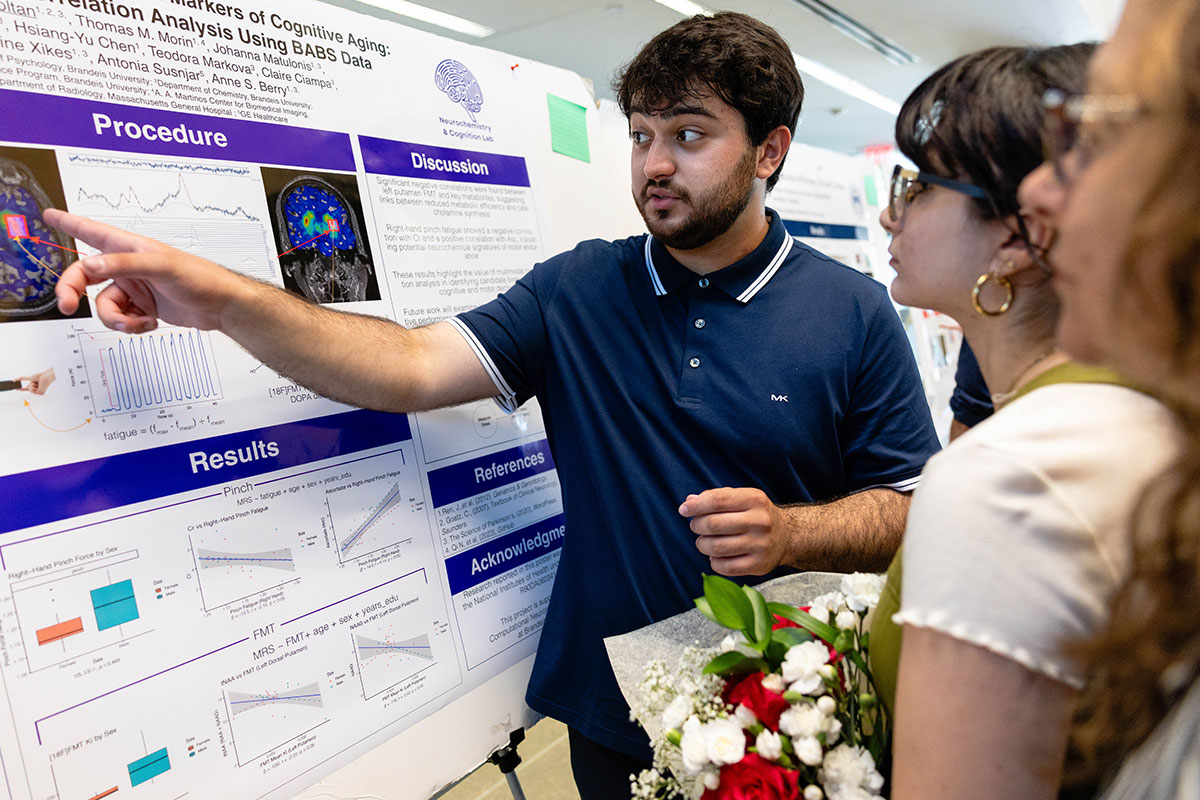 Shaian Aghasoltan ’26 presents his research poster at SciFest.