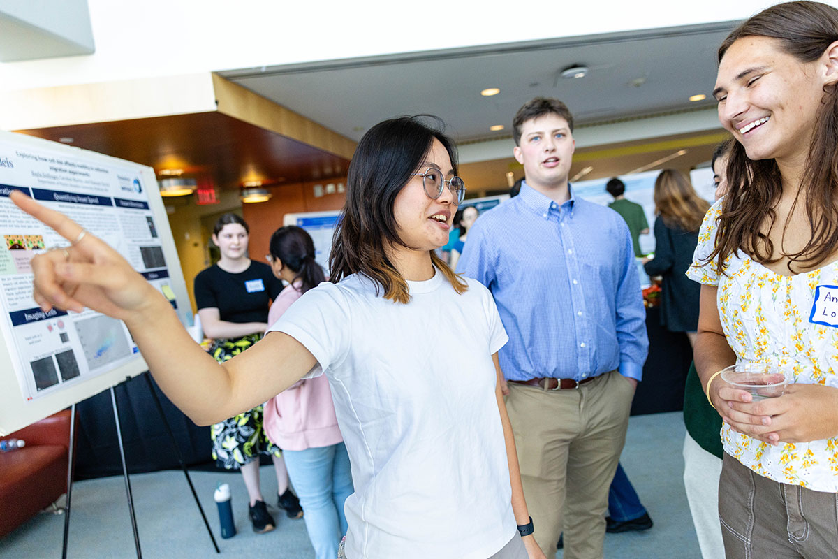 Uyen Bui presents her research poster at SciFest.