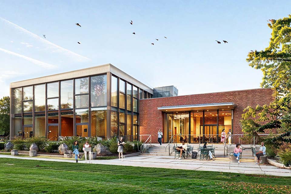 Conceptual rendering of the new Center for Jewish Life. People are seen socializing outside a brick building.