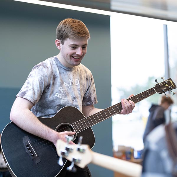 Two student athletes smile and hold frisbees.