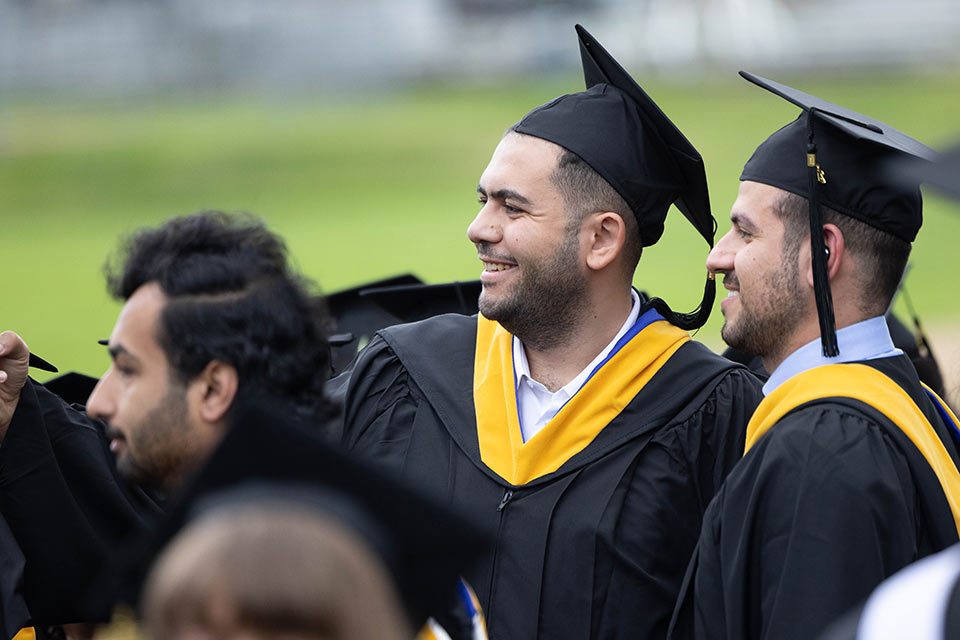 Graduates outside before commencement