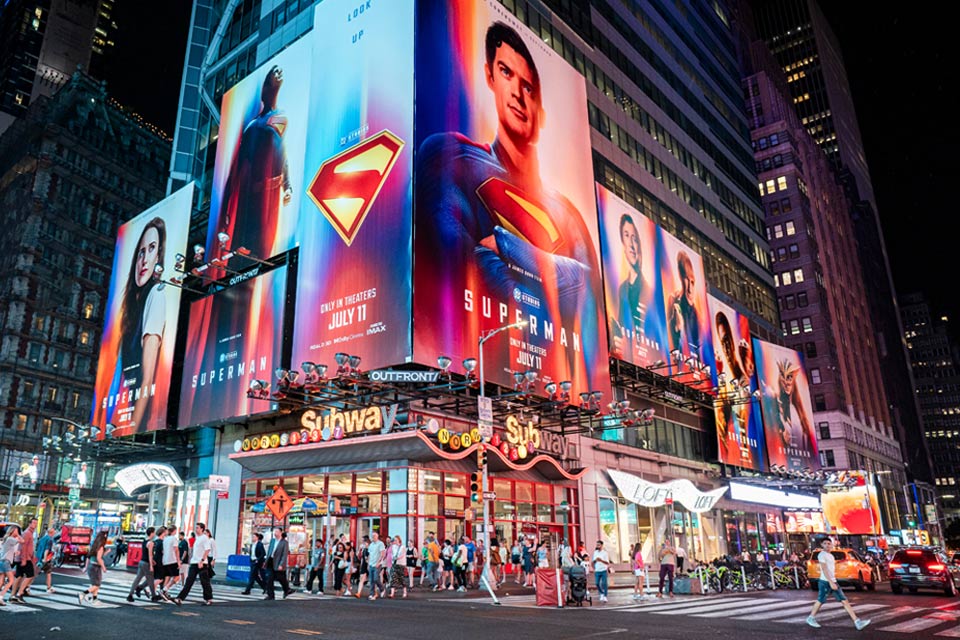 People cross the street near billboards advertising the new "Superman" film in Times Square