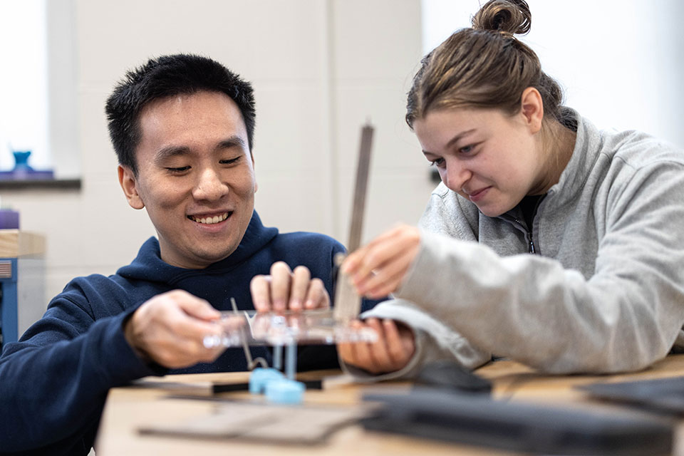 Two students work together in an engineering classroom
