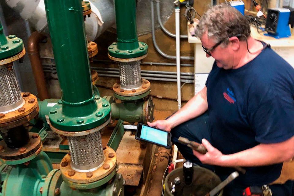 A person checking a water pipe