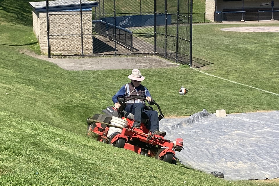A person mowing the lawn