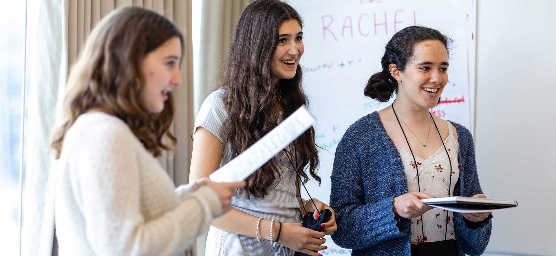 Three Genesis participants smiling, engaged in activities
