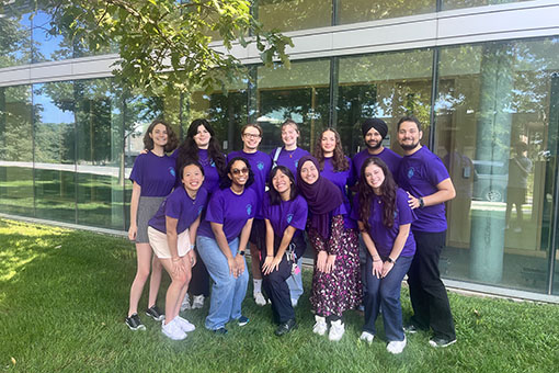 The Roosevelt Fellows team poses in their purple staff shirts.