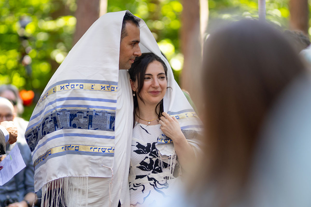 A bride and groom smile together during their wedding ceremony.