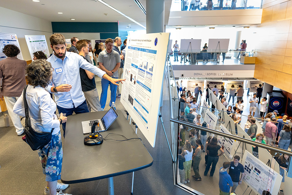 The Shapiro Science Center filled with student presenting their research posters.