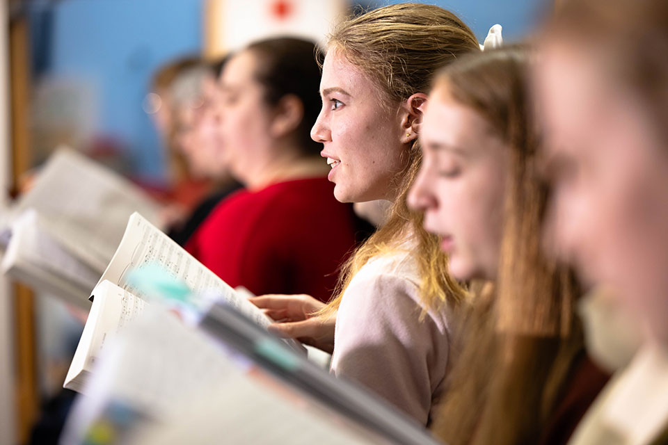 People singing inside the Shapiro Campus Center