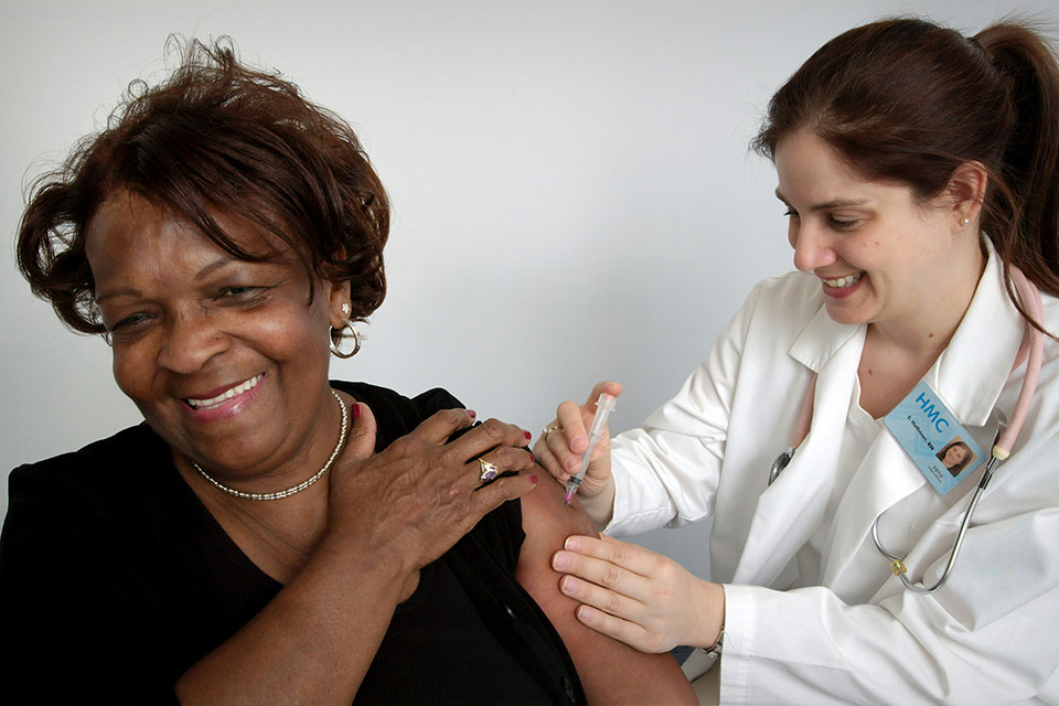 A doctor gives a patient a vaccine.