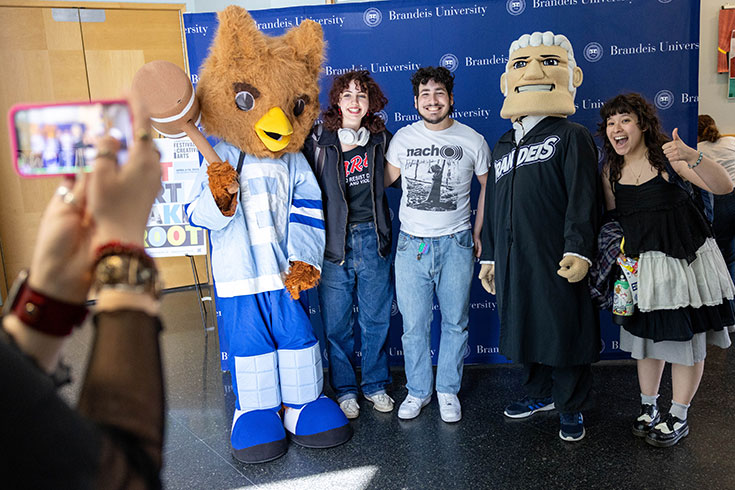 Students pose for a photo next to the Brandeis mascots.